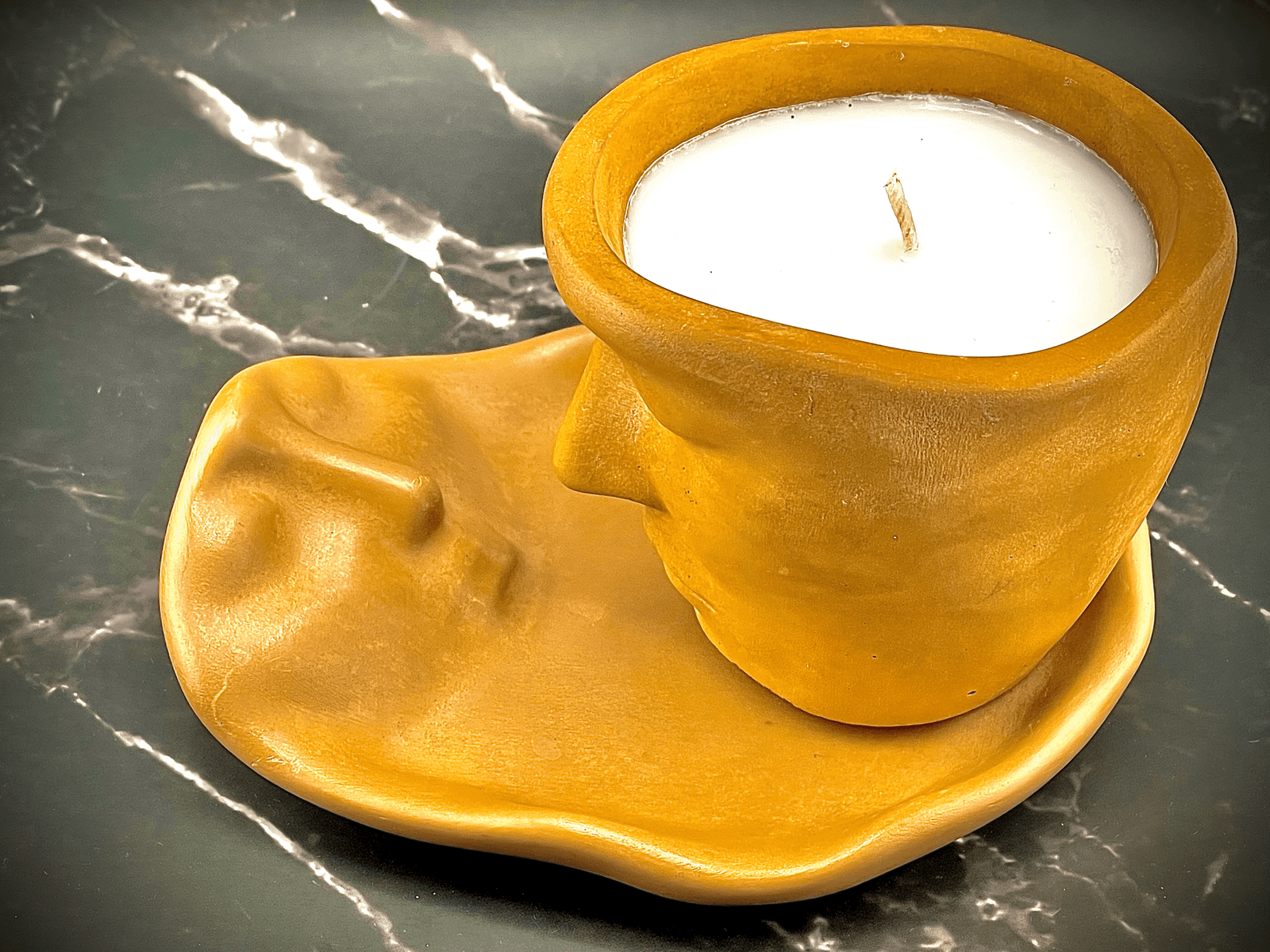 Lucentius Twin Flame candle tray viewed from above, female silhouette with male jar on top, beige concrete, top-down view